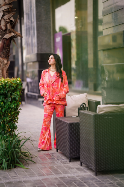 Borealis set - three-piece tie-dye blazer set with tube top and flared pants, vibrant orange and pink outfit, casual and chic women's fashion set, retro-inspired high-waist flared pants.